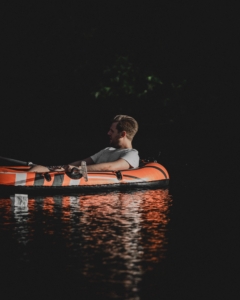 man floating down a river in a raft