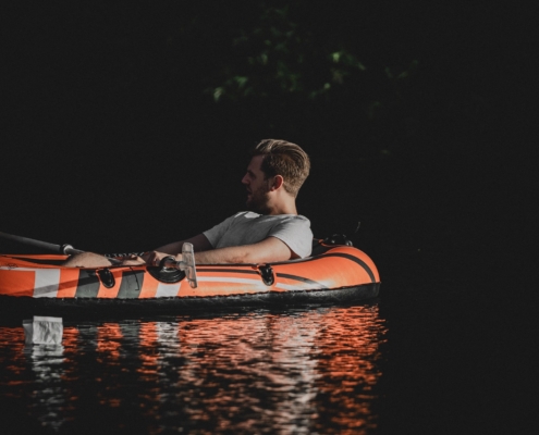 man floating down a river in a raft